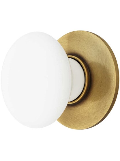 1 3/8 inch White Porcelain Cabinet Knob With Brass Rosette in Antique Brass.